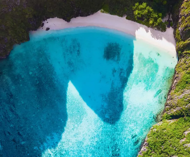 Experience paradise on our Phi Phi Maya & Khai Explorer tour - swim in this secret cove with pristine white sand beaches and breathtaking gradient of turquoise waters perfect for snorkeling, surrounded by dramatic cliffs that create an unforgettable tropical escape.